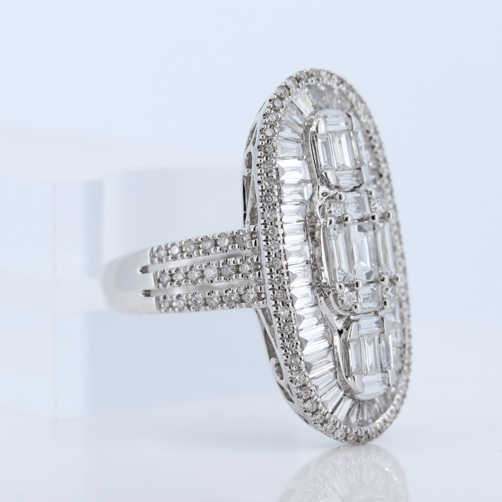 18Kw Elongated Oval Diamond Ring With Round And Step Emerald Cut Diamonds. D-2.65
