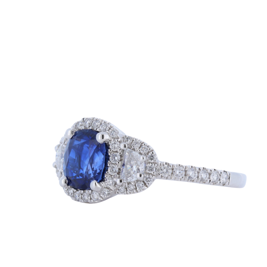 Three Stone Cushion Cut Sapphire Ring With Half Moon Cut And Halo Diamonds In Platinum