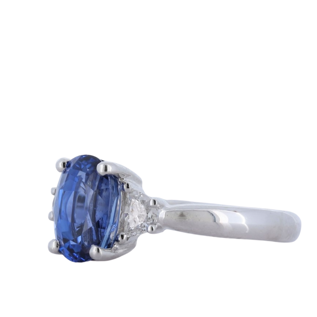 Platinum Sapphire Three Stone Ring With Center Oval And Half Moon Cut Diamond Sides
